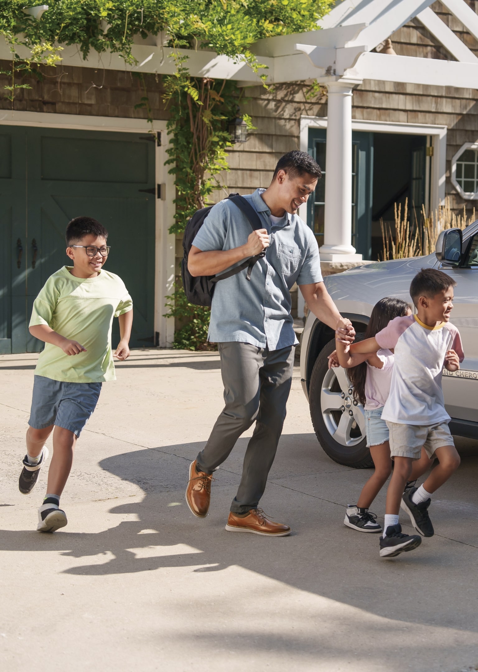 The featured image is a man wearing Nunn Bush shoes while he and his kids run to a parked car in their driveway.