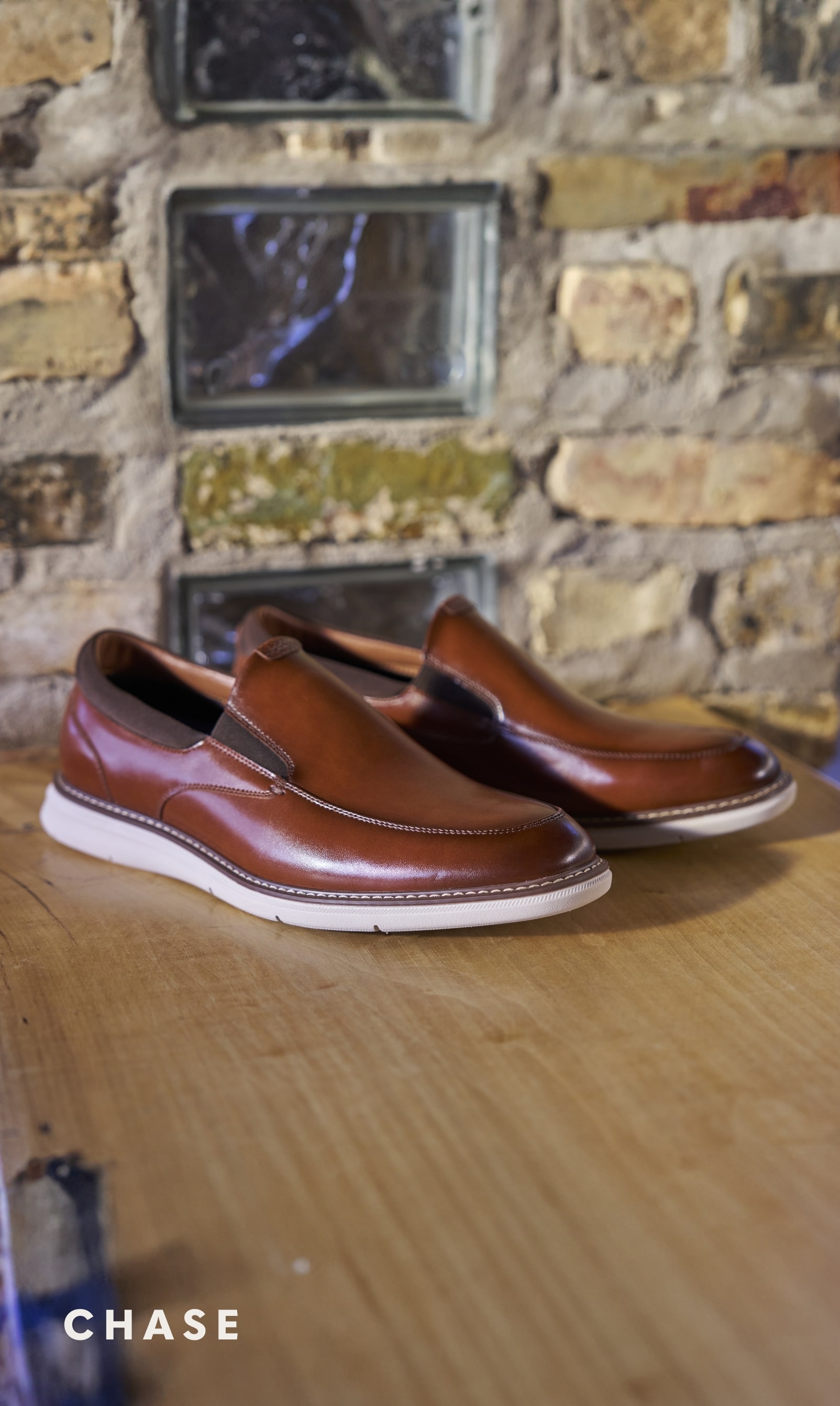 Men's Casual Shoes category. Image features the Chase slip on in cognac. 